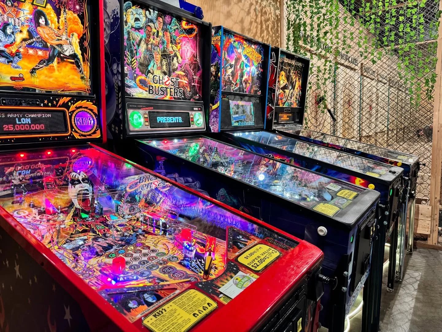 Row of pinball machines at Pacific Axes