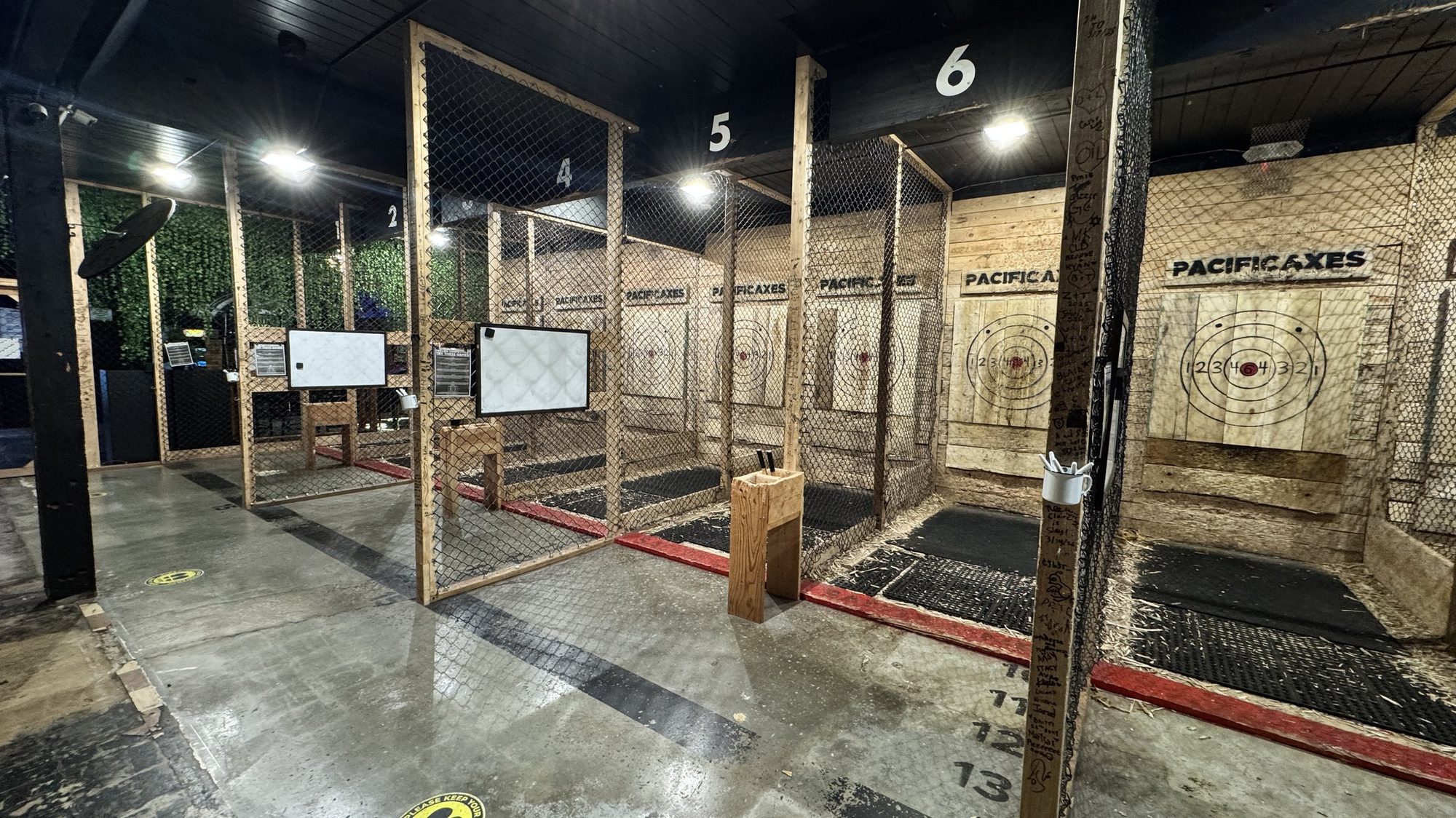 Six indoor axe throwing lanes with wooden targets
