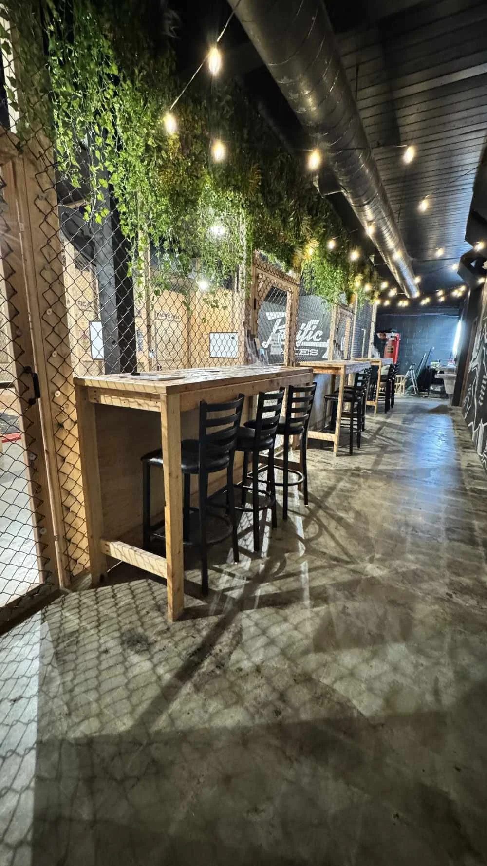 High tables and greenery in the Pacific Axes lounge